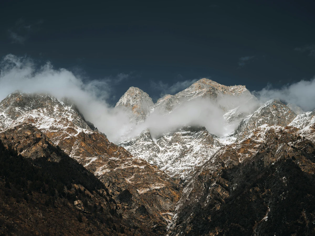 Snow Capped Himalayan Peaks Under Dramatic Sky