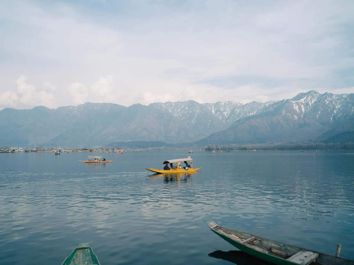 Traditional Wooden Houseboats Boats on Dal Lake between Mountains in Kashmir