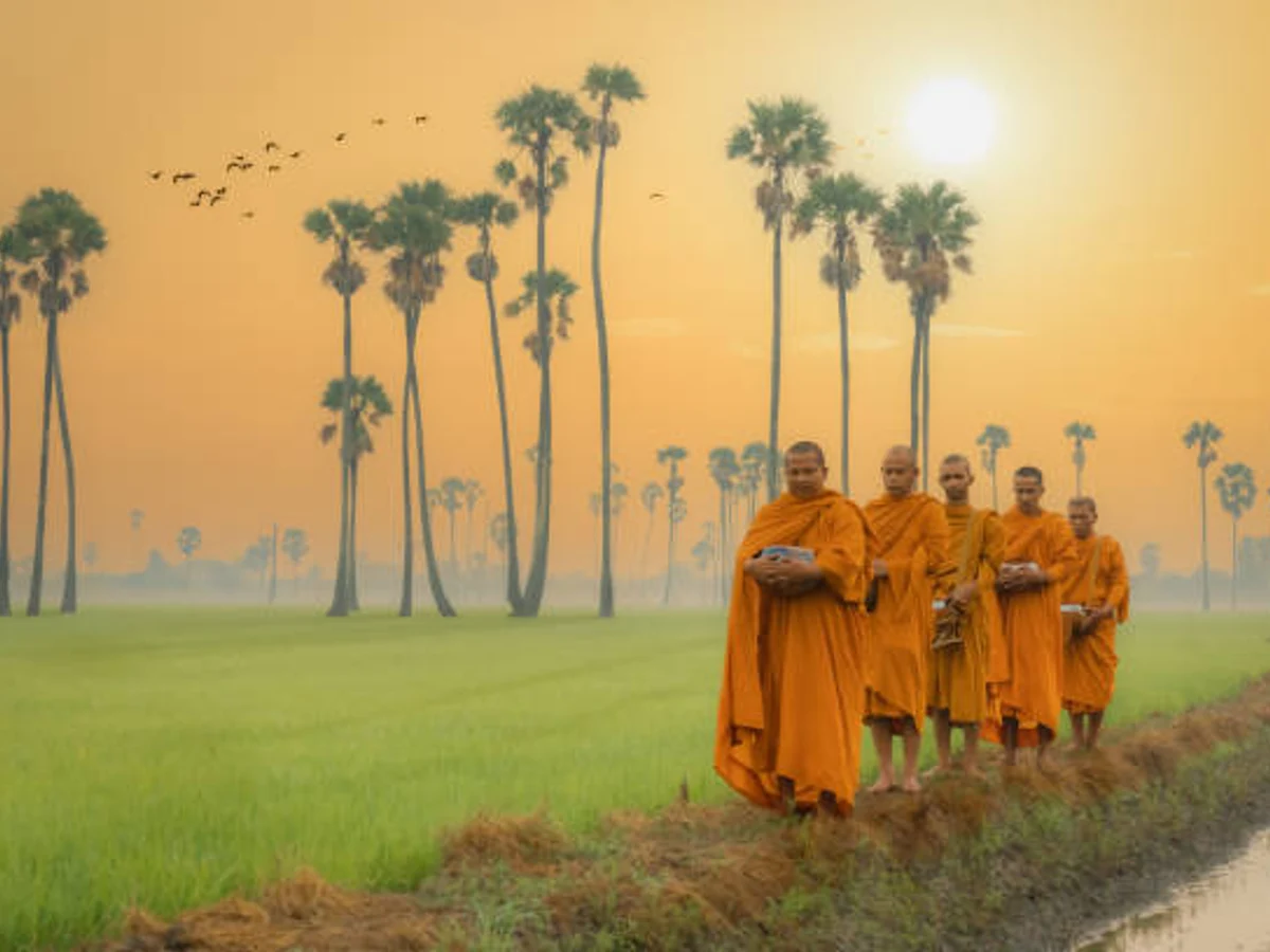 Buddhist monks going about to receive food from villager in morning in Thailand