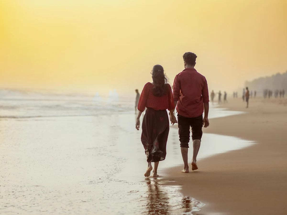Couple walking on the beach holding hand