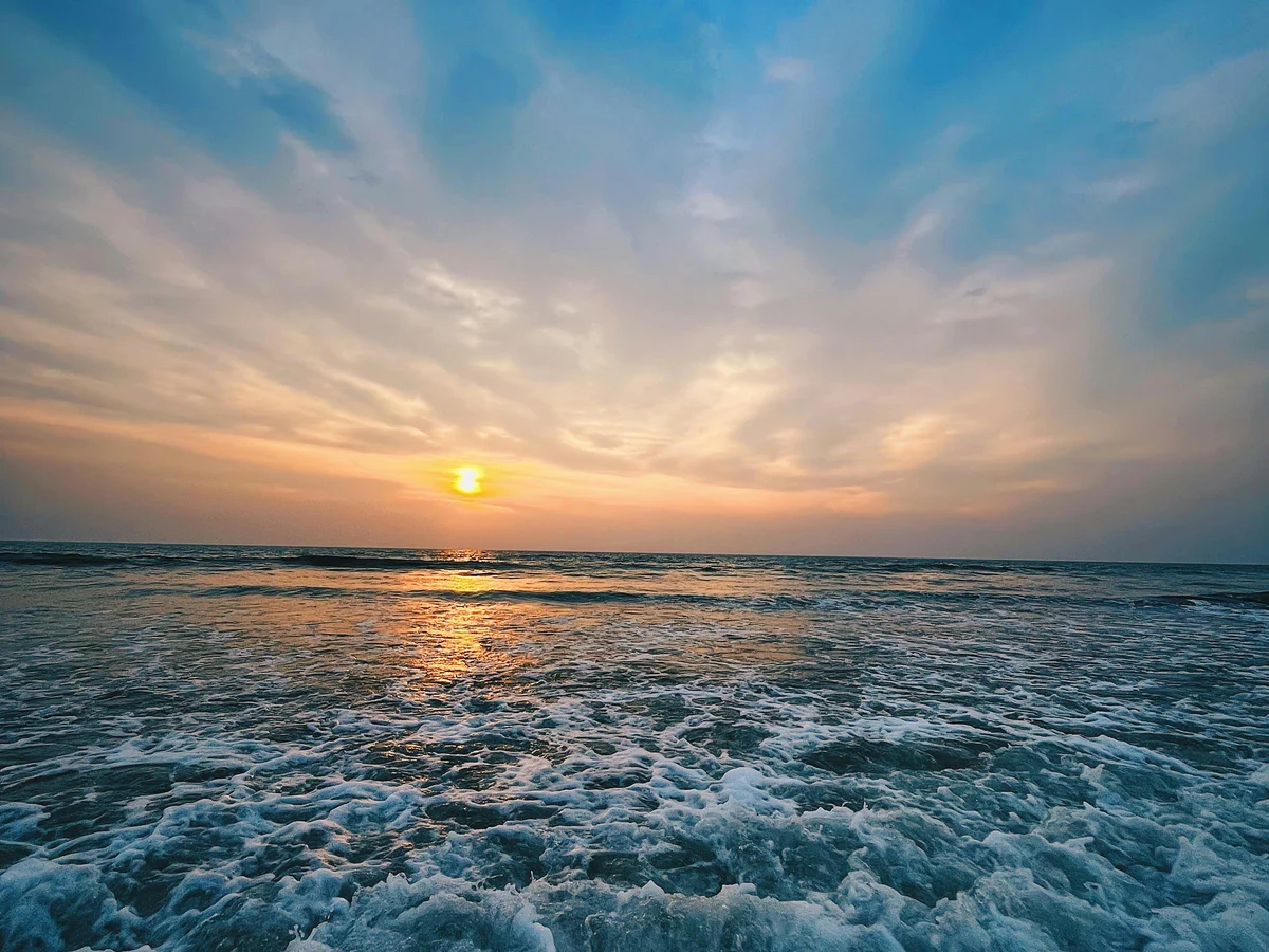 Stunning Beach Sunset with Vibrant Sky and Waves