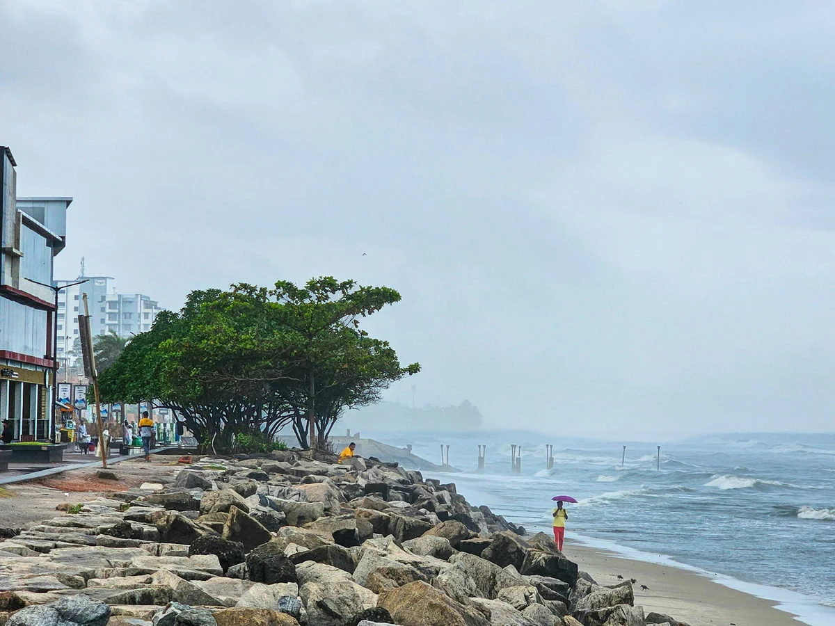 Rainy Day at Kozhikode Beach with Rocky Shore