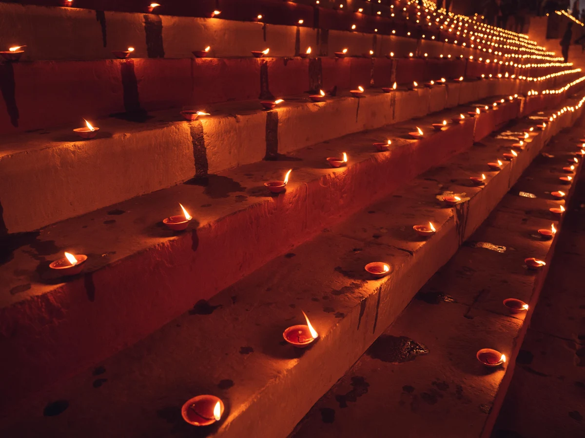 Burning Candles in Rows on Walls
