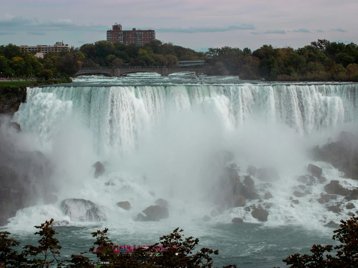 Majestic view of Niagara Falls cascading into the river below on a calm day, ON, Canada