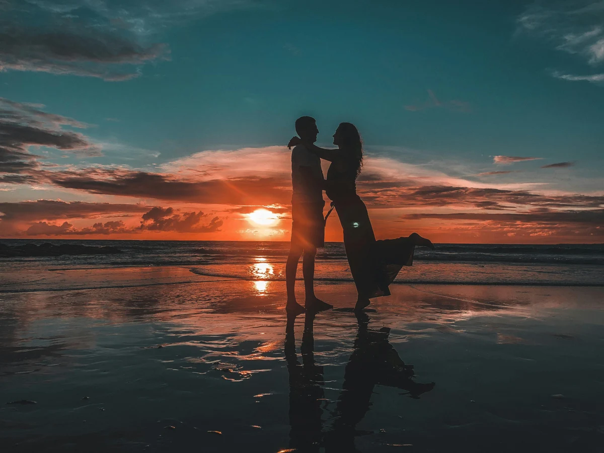 Silhouette of a Couple Standing on Beach during Sunset Bali