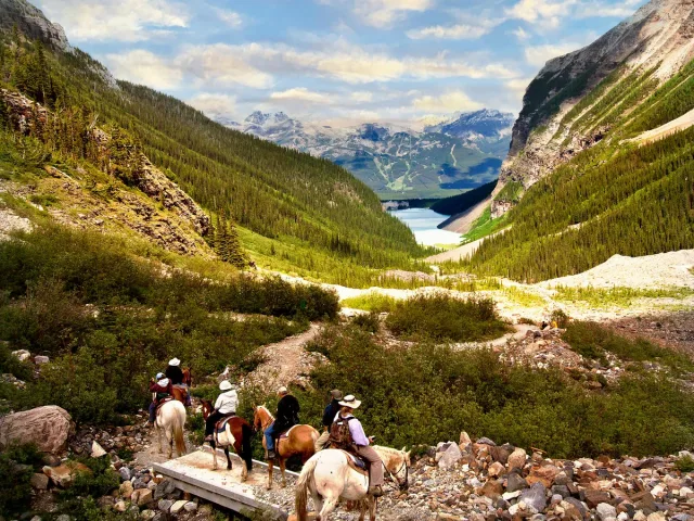 People Riding Horses on Footpath in Banff National Park in Canada