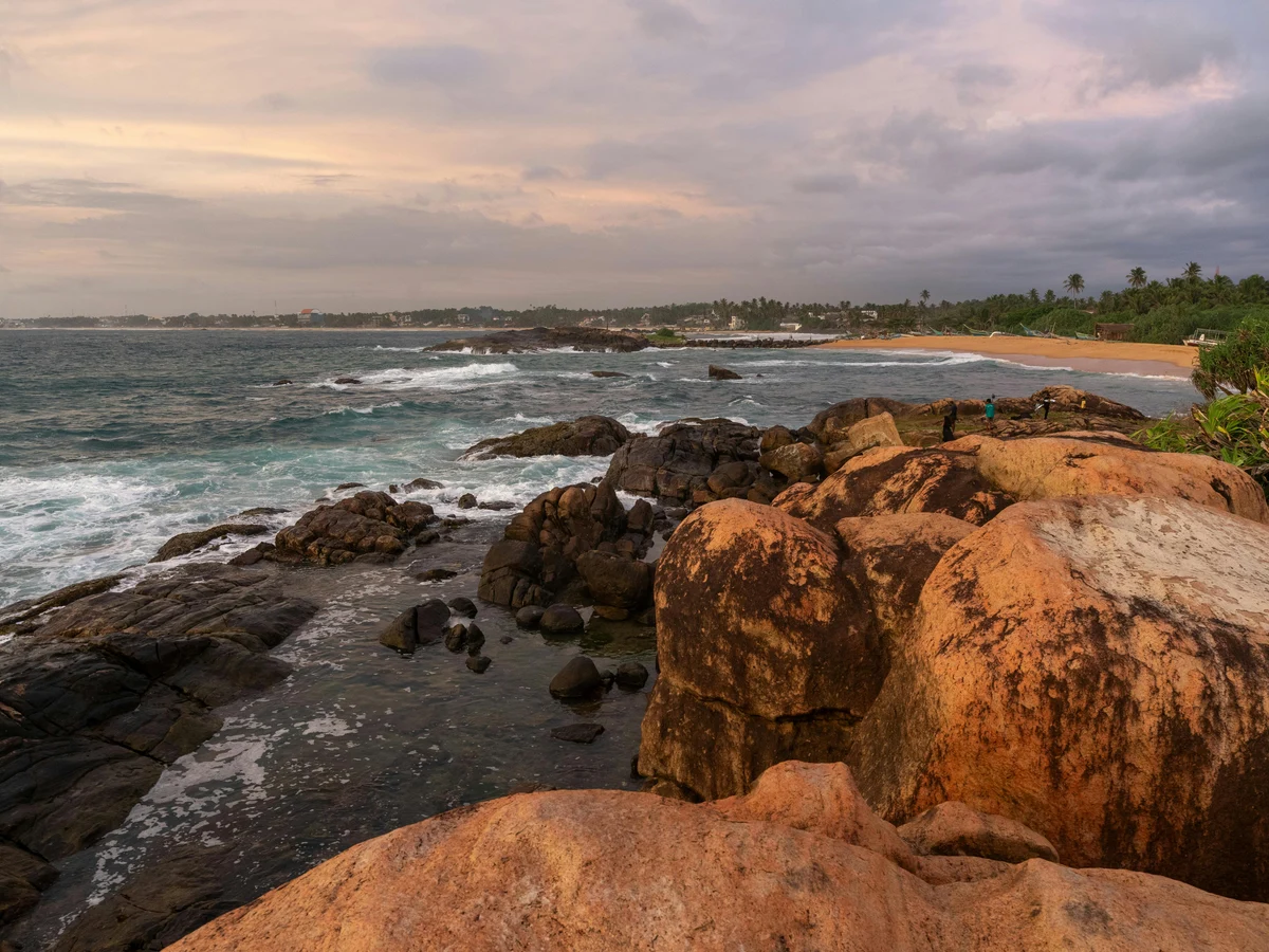 Scenic Beach at Sunset with Rocky Shoreline, Shri Lanka
