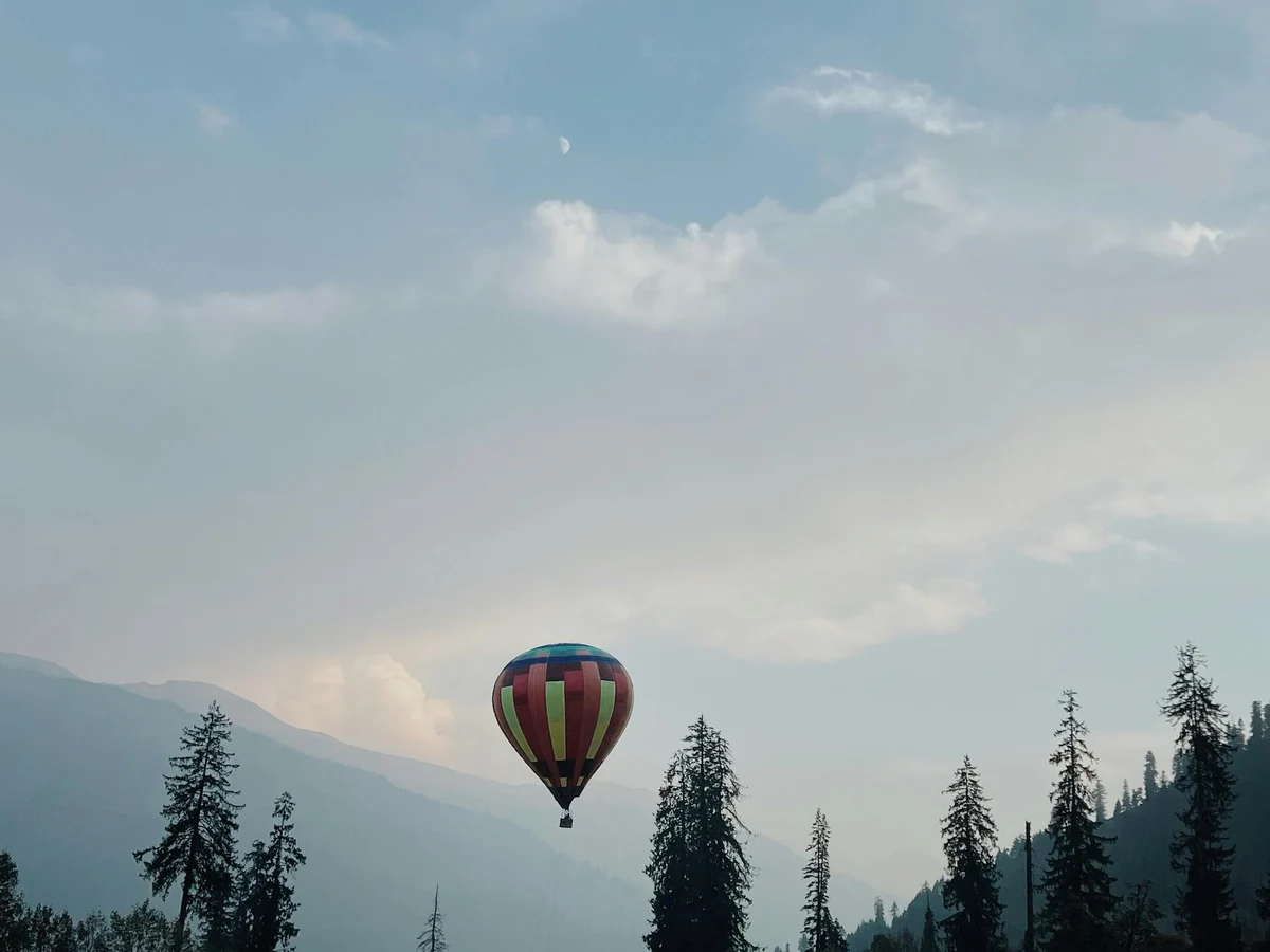Colorful Hot Air Balloon Over Scenic Mountains