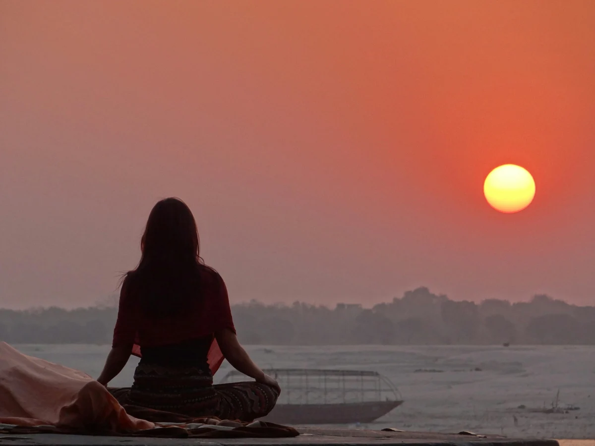 Woman Doing Yoga Near Sea during Sunset