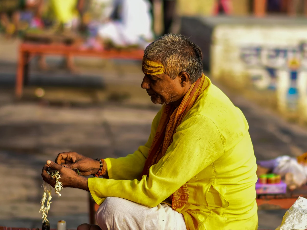 Sadhu Surrounded by Devotional Items