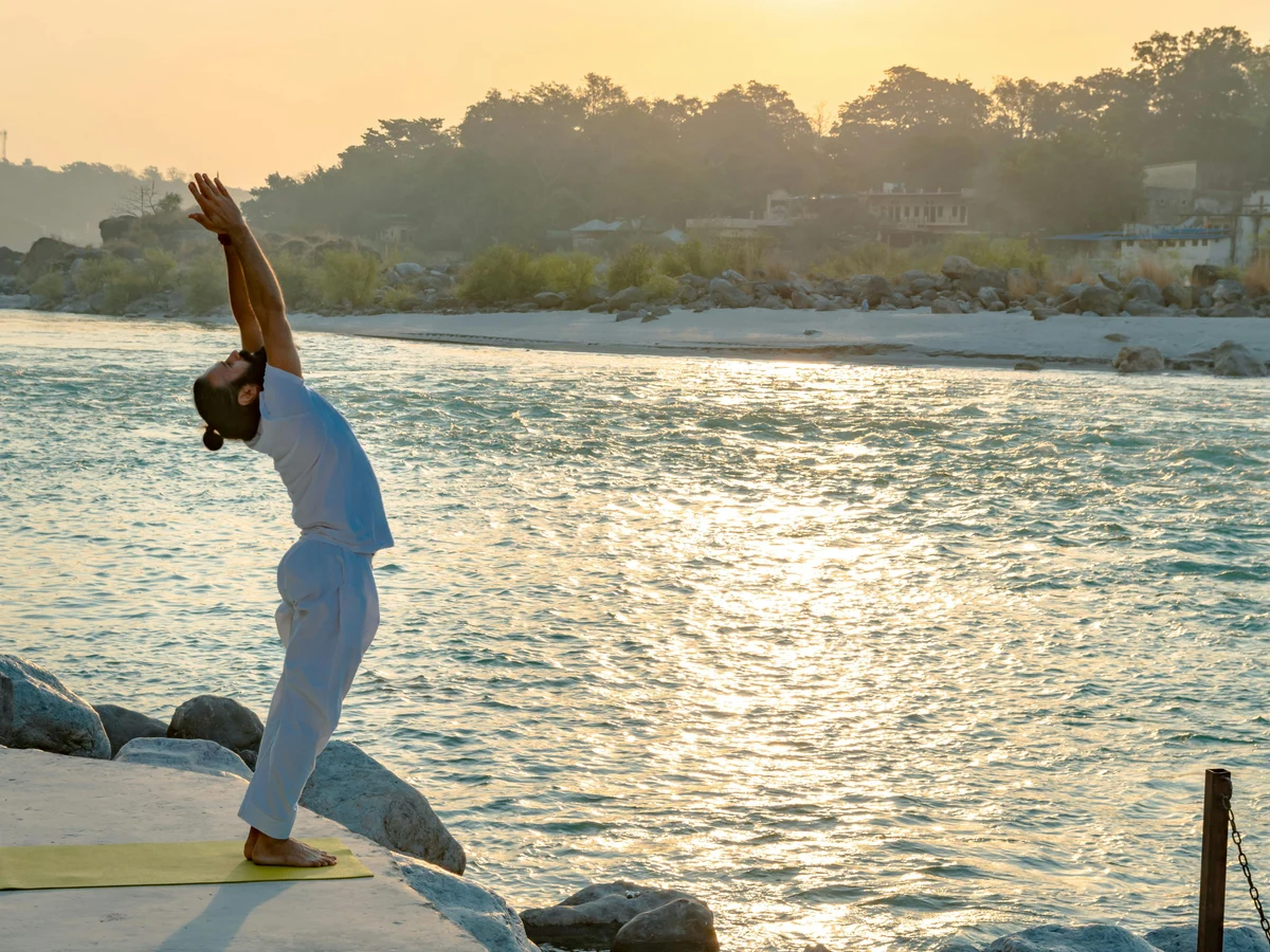A Man in White Shirt Doing Yoga