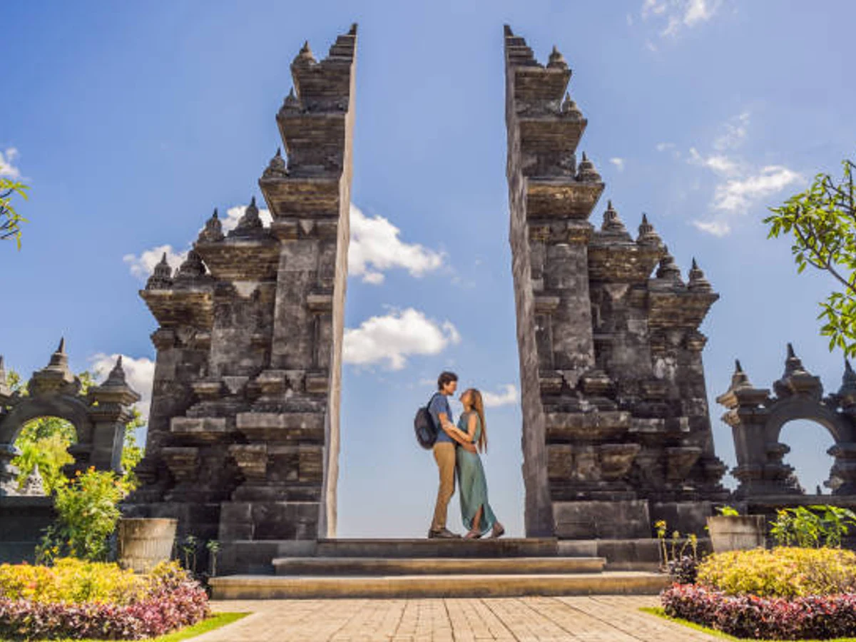 Loving couple of tourists in budhist temple Brahma Vihara Arama Banjar Bali, Indonesia. Honeymoon.