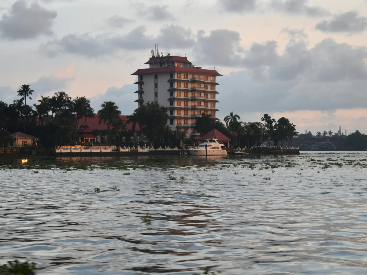 Riverside View with Hotel and Palm Trees at Sunset