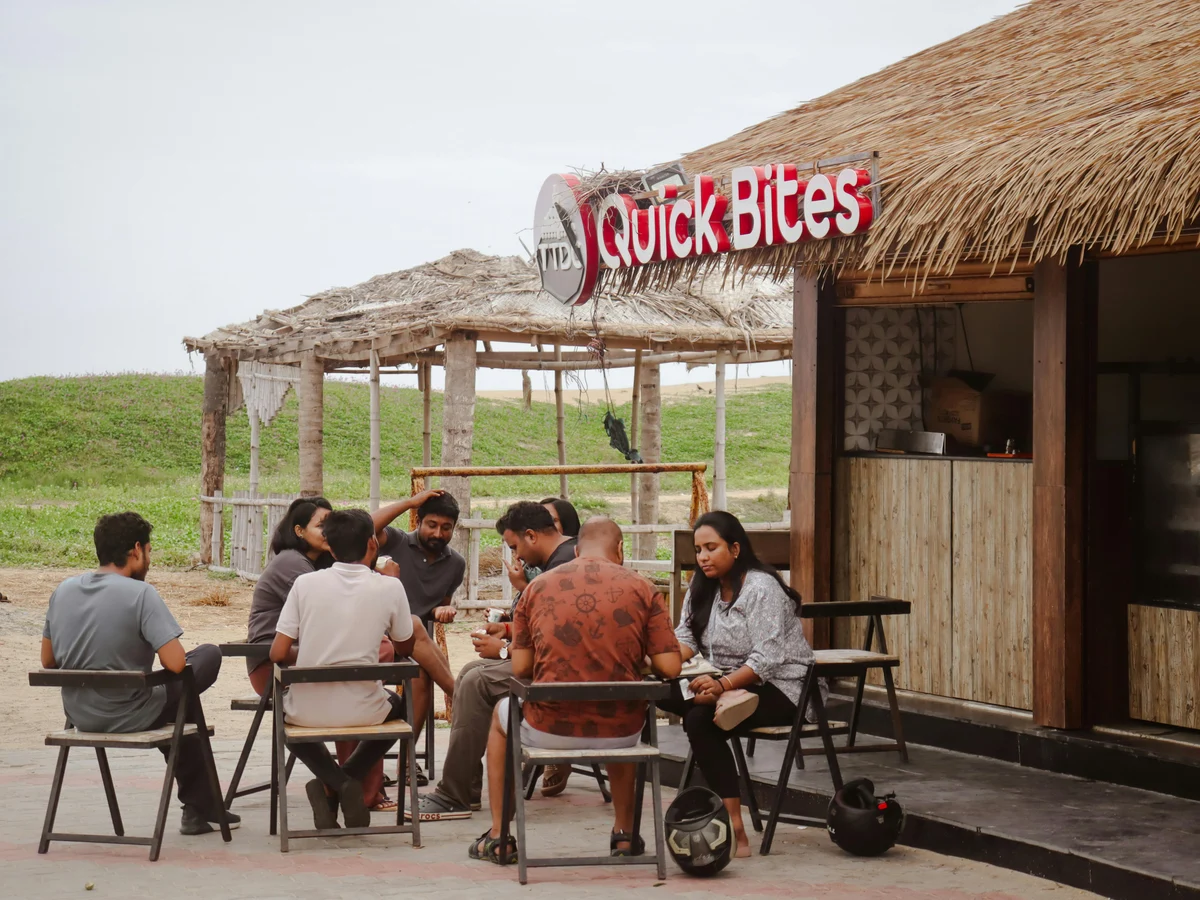 Group Enjoying Outdoor Café by Beach