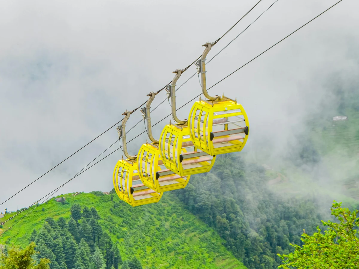 Yellow Cable Cars in Misty Mountain Landscape