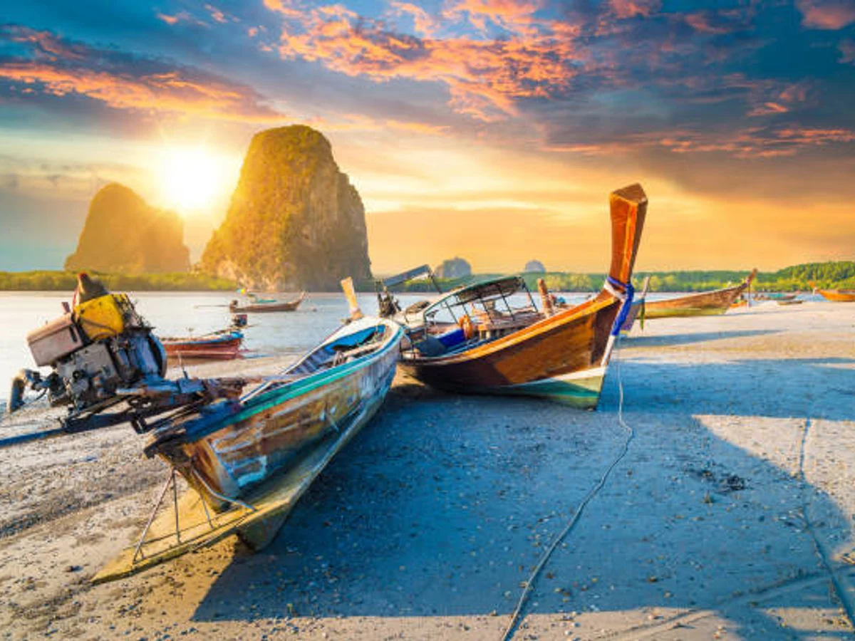 Beautiful sunset at tropical sea with long tail boat in Krabi, thailand