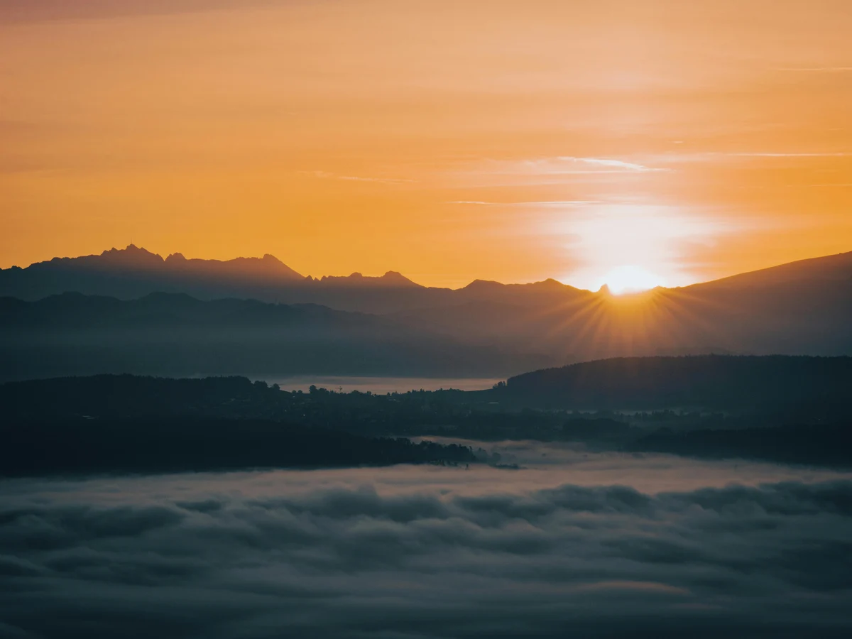 Dramatic Sunrise Over Mountain Range and Clouds