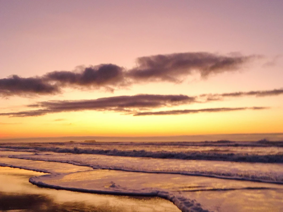 Serene Sunset Over a Tranquil Beach Shoreline