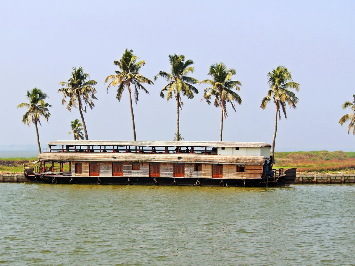 Traditional Houseboat with Palm Trees in Kerala